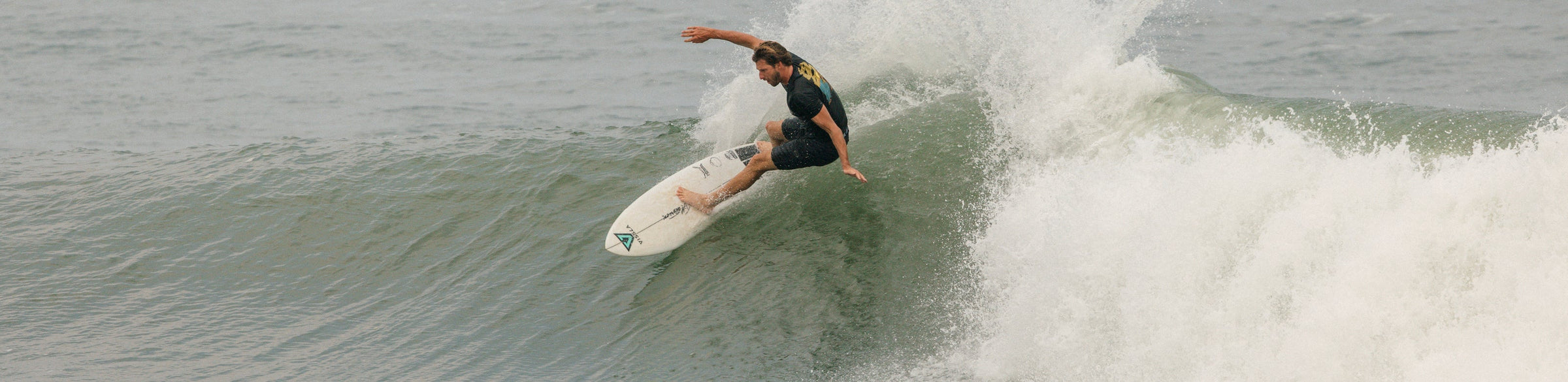 Photo of surfer Eric Geiselmanin a Vissla Comp Lite Dri Release Tee