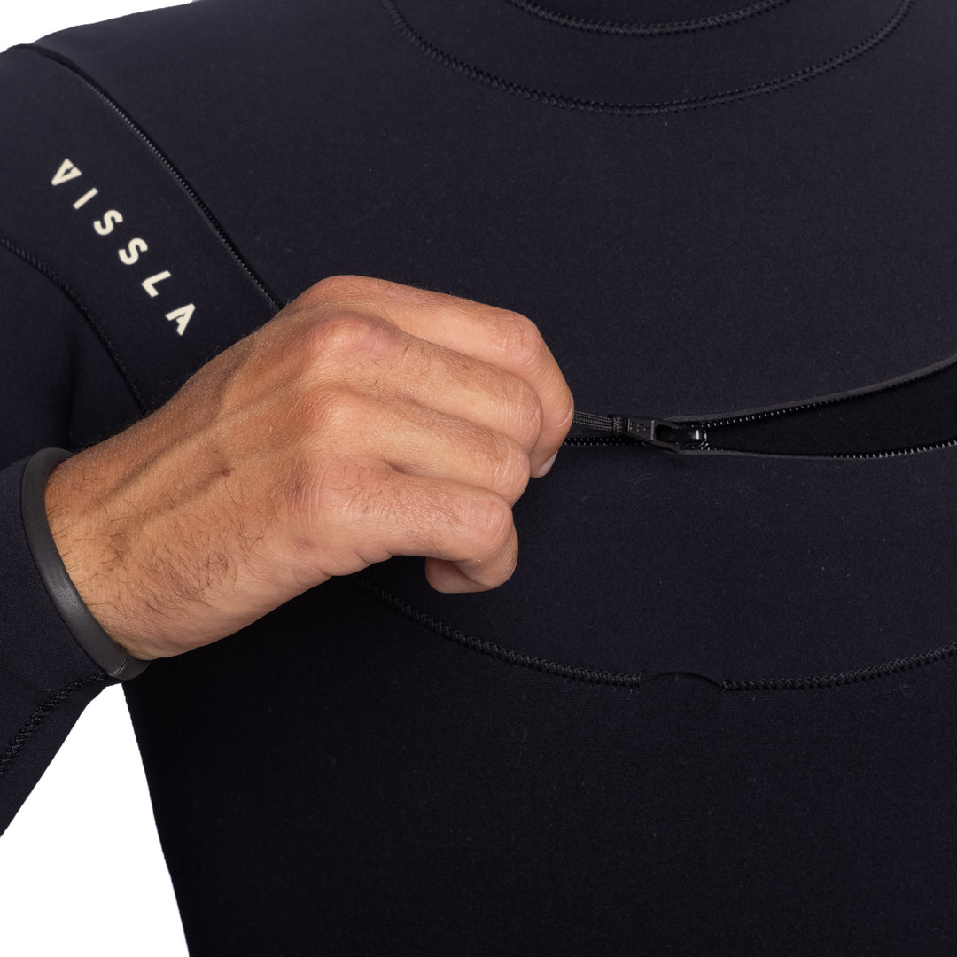 Vissla X Axxe Men's 3-3 U Zip Full Suit. Chest Close Up of Model Pulling Zipper.