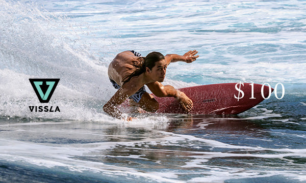 Vissla $100 gift card with logo on top of an image of a surfer doing a turn