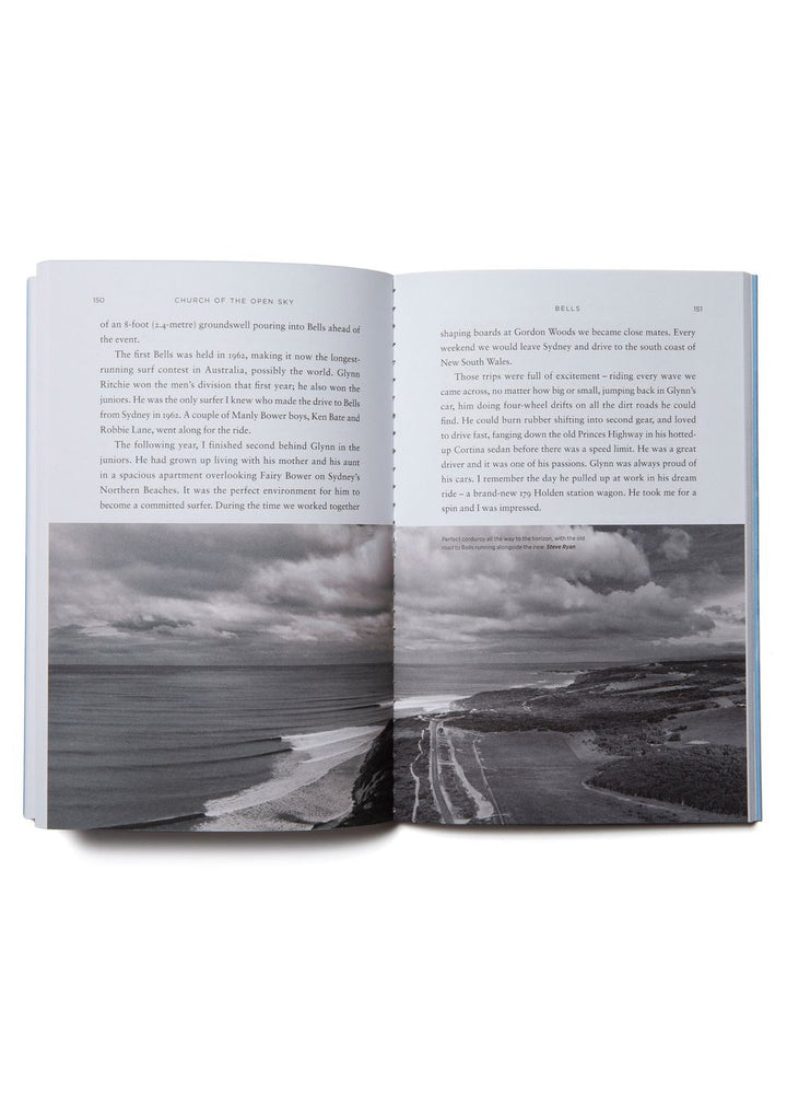 An open book with a black and white picture of waves and a beach running across the bottom of both pages